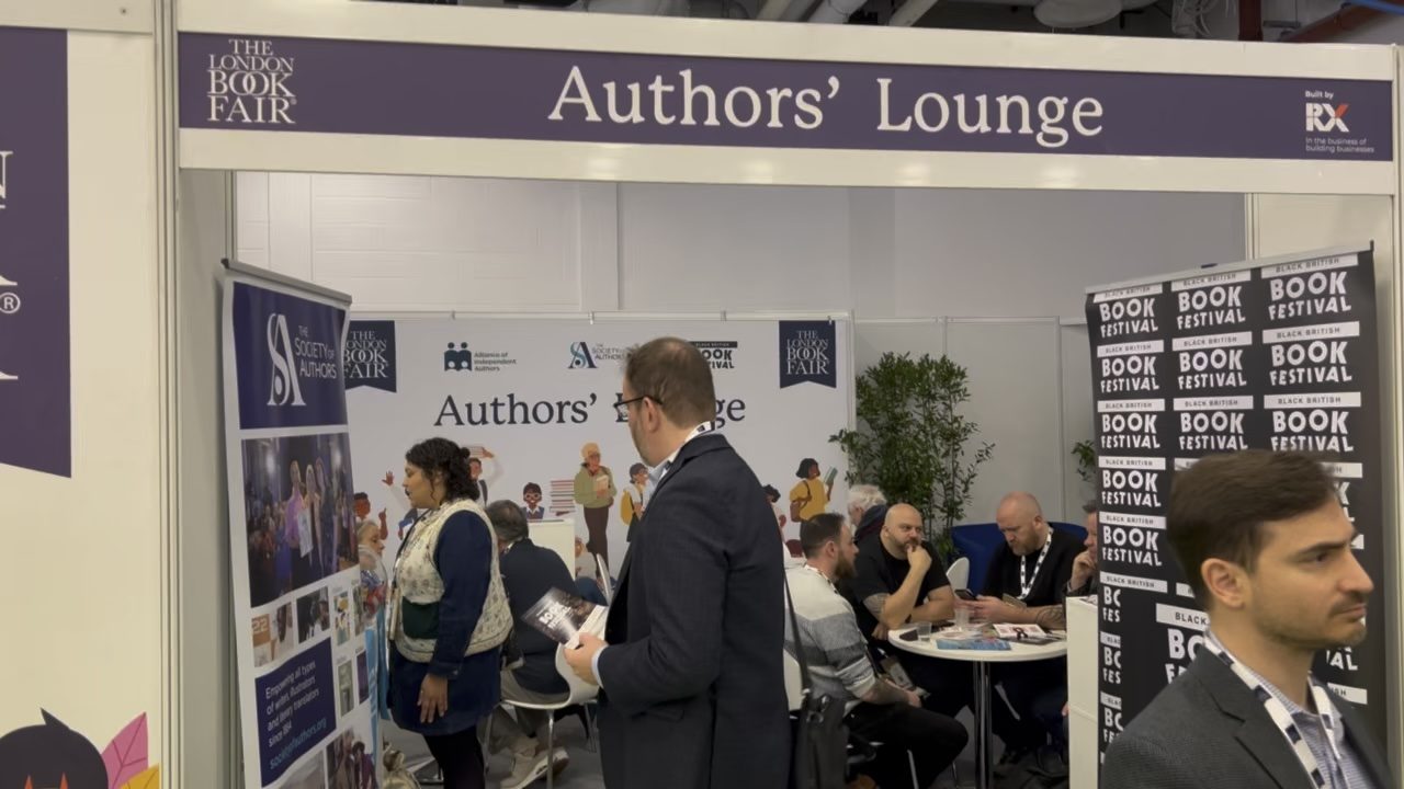 The Authors' Lounge at the London Book Fair, with Society of Authors banners and people talking at tables